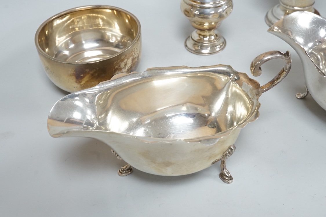 Two George V silver sauceboats, one by Asprey & Co, a silver pepperette, a silver bowl and a modern silver sugar caster, 16oz.